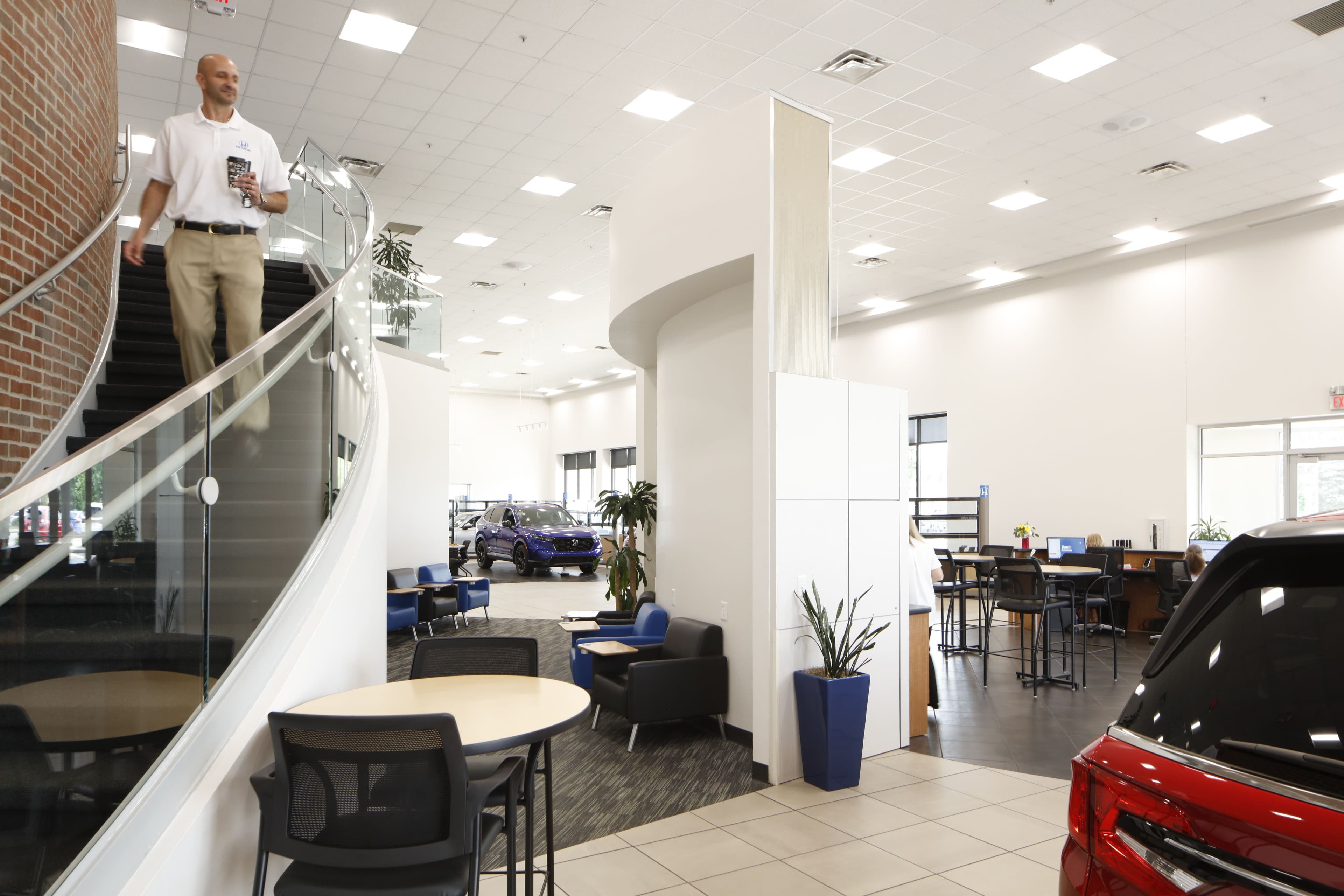 person walking down stairs into car lobby